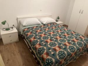 a bedroom with a bed with a quilt on it at Desa's place in Babino Polje