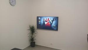a flat screen tv hanging on a white wall at Appartamento perla in Rome