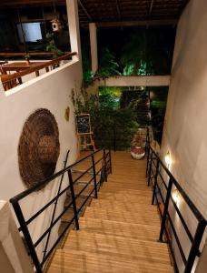 a staircase leading up to a room with a basket on the wall at Pousada Villa Bougainville Maragogi in Maragogi