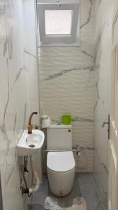 a bathroom with a toilet and a sink at Rèsidance Mimosa in Bejaïa +21 photos