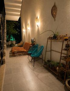 a living room with a couch and a chair at Pousada Villa Bougainville Maragogi in Maragogi