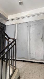 a room with two large glass doors with writing on it at Rèsidance Mimosa in Bejaïa