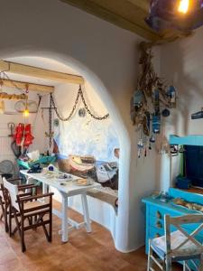 a room with a table and a table and chairs at Palirroia (High Tide) in Empourios