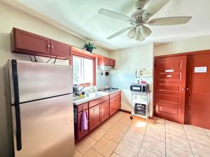 a kitchen with a refrigerator and a ceiling fan at One Bus Stop to Time Square-4BR Duplex-Free Parking in Hillside