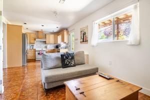 a living room with a couch and a wooden table at Serene Garden Suite in Delta
