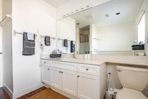 a white bathroom with a sink and a toilet at Serene Garden Suite in Delta +16 photos