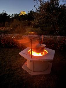 a fire pit with a bucket on top of it at Vitamin K73 Vendégház in Boldogkőváralja