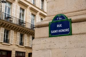 a street sign on the side of a building at 336 Saint-Honore By Chapitre Collection in Paris