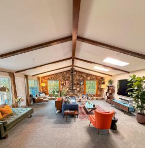 a large living room with couches and chairs at Mountain Daddies Boutique Bed & Breakfast near Yosemite - Fresh Homemade Breakfast Included in Oakhurst