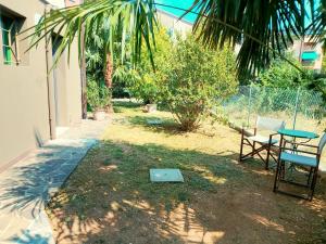 a patio with a table and two chairs and a table at Ciconi Garden Studio Apartment in Gorizia +2 photos