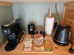 a desk with a coffee maker and a toaster at L'Escapade du Puy in Saint-Amand-sur-Sèvre