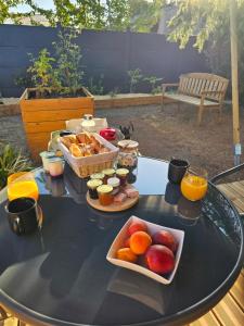 a table with a tray of fruit and drinks on it at L'Escapade du Puy in Saint-Amand-sur-Sèvre +11 photos