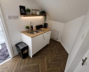 a small kitchen with a sink and a counter at Northenden Stayzzz in Manchester