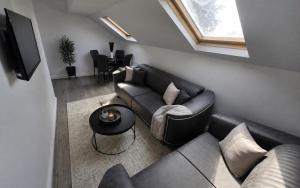 a living room with a couch and a table at Northenden Stayzzz in Manchester +3 photos
