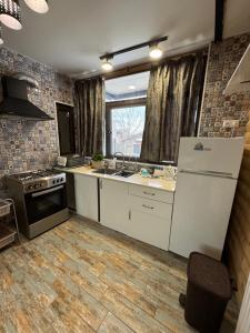 a kitchen with a white refrigerator and a stove at Georgios Ranch in Tsodoreti