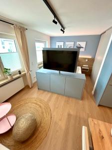 a living room with a large flat screen tv at Inselliebe Norderney in Norderney
