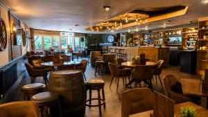 a restaurant with tables and chairs and a bar at The Park Hotel - Sure Hotel Collection by Best Western in Diss