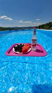 a drink and a plate of food on a tray in the water at Nature House in Pljevlja +4 photos
