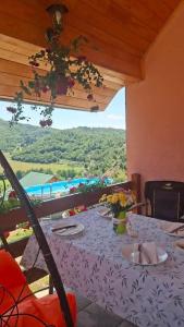 a table with a purple table cloth and a view at Nature House in Pljevlja