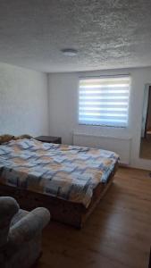 a bedroom with a bed in a room with a window at Nature House in Pljevlja