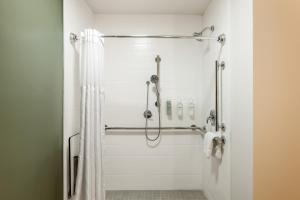 a bathroom with a shower with a shower curtain at Spark By Hilton Freeport in Freeport +24 photos