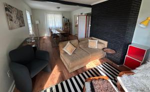a living room with a couch and a chair at Charming Roanoke Guesthouse in Roanoke