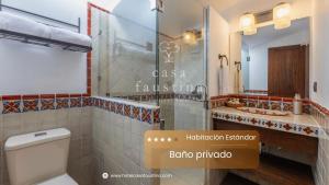 a bathroom with a toilet and a shower and a sink at Casa Faustina Boutique Hotel in Antigua Guatemala