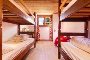 two bunk beds in a room with a christmas tree at Chalet Dava La Via ski in - ski out - Happy Rentals in Chamonix +22 photos