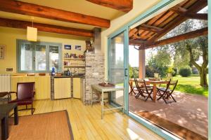 a kitchen and dining room with a patio with a table at Chalet Vignarola - Happy Rentals in Orbetello