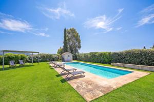 a swimming pool with lounge chairs in a yard at Chalet Vignarola - Happy Rentals in Orbetello +38 photos