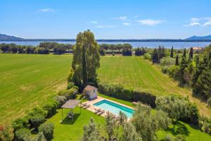 an aerial view of a large field with a house and a swimming pool at Chalet Vignarola - Happy Rentals in Orbetello