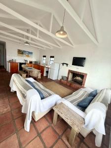 a living room with a couch and a fireplace at Coast Cottages Langebaan in Langebaan
