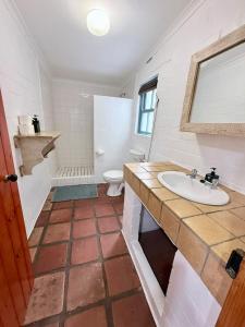 a bathroom with a sink and a toilet at Coast Cottages Langebaan in Langebaan +26 photos
