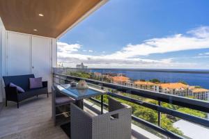 a balcony with a table and a view of the ocean at Monumental Apartments - Multi Listing in Funchal