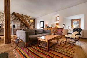 a living room with a couch and a table at Chalet l'Arva in Saint-Marcel