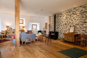 a living room with a stone wall at Chalet l'Arva in Saint-Marcel