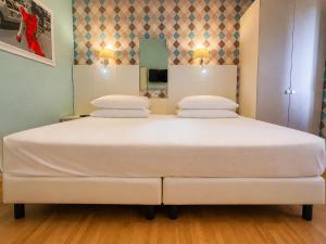a bedroom with a large white bed with two pillows at B&B Pellicano Guest House in Reggio di Calabria +23 photos