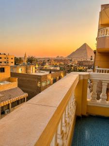 a view of the pyramids from the balcony of a building at Miami Pyramids View in Cairo