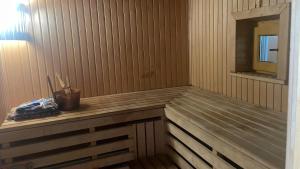 a sauna with a wooden counter and a mirror at Upes lillijas in Jelgava