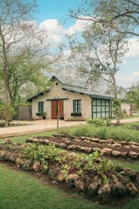 a stone house with a garden in front of it at Chablé Yucatan in Chocholá