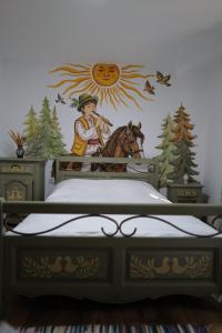a bedroom with a mural of a man riding a horse at Raiul Sânzienelor in Sărata-Monteoru