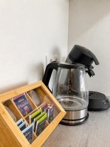 a tea kettle sitting next to a box of matches at Fewo ONE - by Europapark in Rust +5 photos