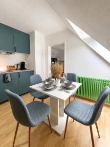 a kitchen and dining room with a table and chairs at Fewo ONE - by Europapark in Rust