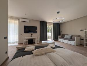 a large bedroom with a large bed and a couch at Apartmány Villa Vician in Piešťany