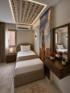 a bedroom with a large bed and a mirror at Miami Pyramids View in Cairo