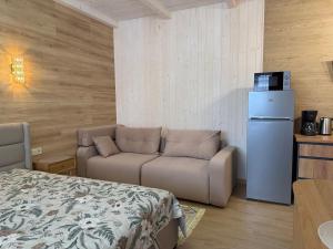 a living room with a couch and a refrigerator at Bukovets' in Yaremche