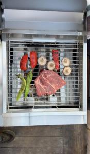 a rack of meat and vegetables in an oven at 今帰仁森風テラス in Nakijin