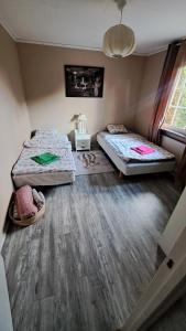 a bedroom with two beds and a window at Villa Tingsryd nära stranden in Tingsryd