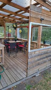 a wooden deck with a table and chairs on it at Villa Tingsryd nära stranden in Tingsryd