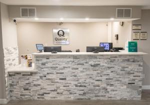 a stone counter with two laptops on top of it at Quality Inn Texarkana Arkansas in Texarkana